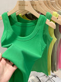 Women's plain tank top with a round neck and ribbed texture.