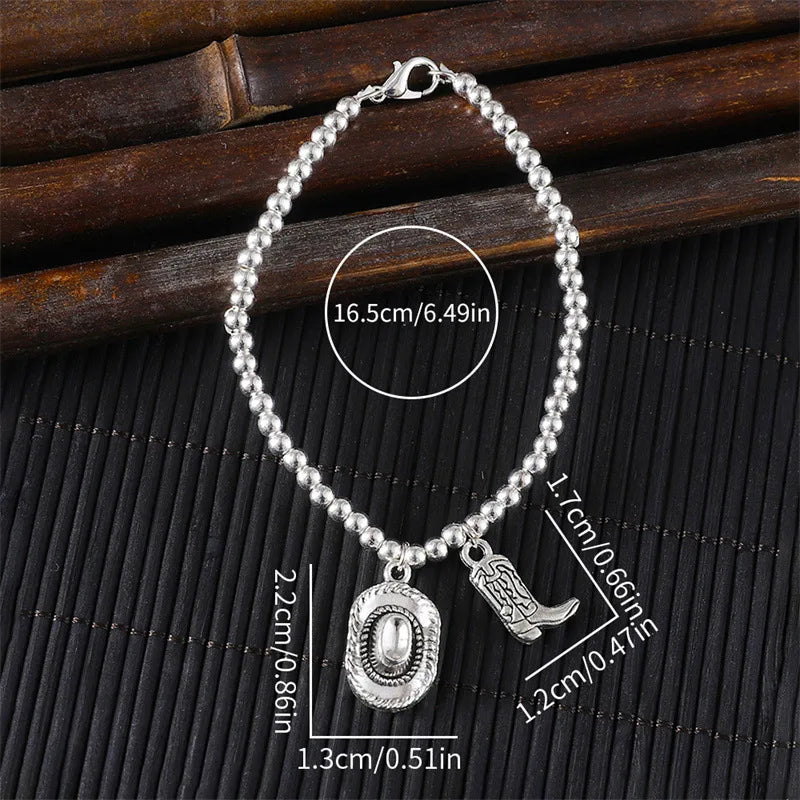 Vintage chain bracelet with cowboy hat and boots pendant.