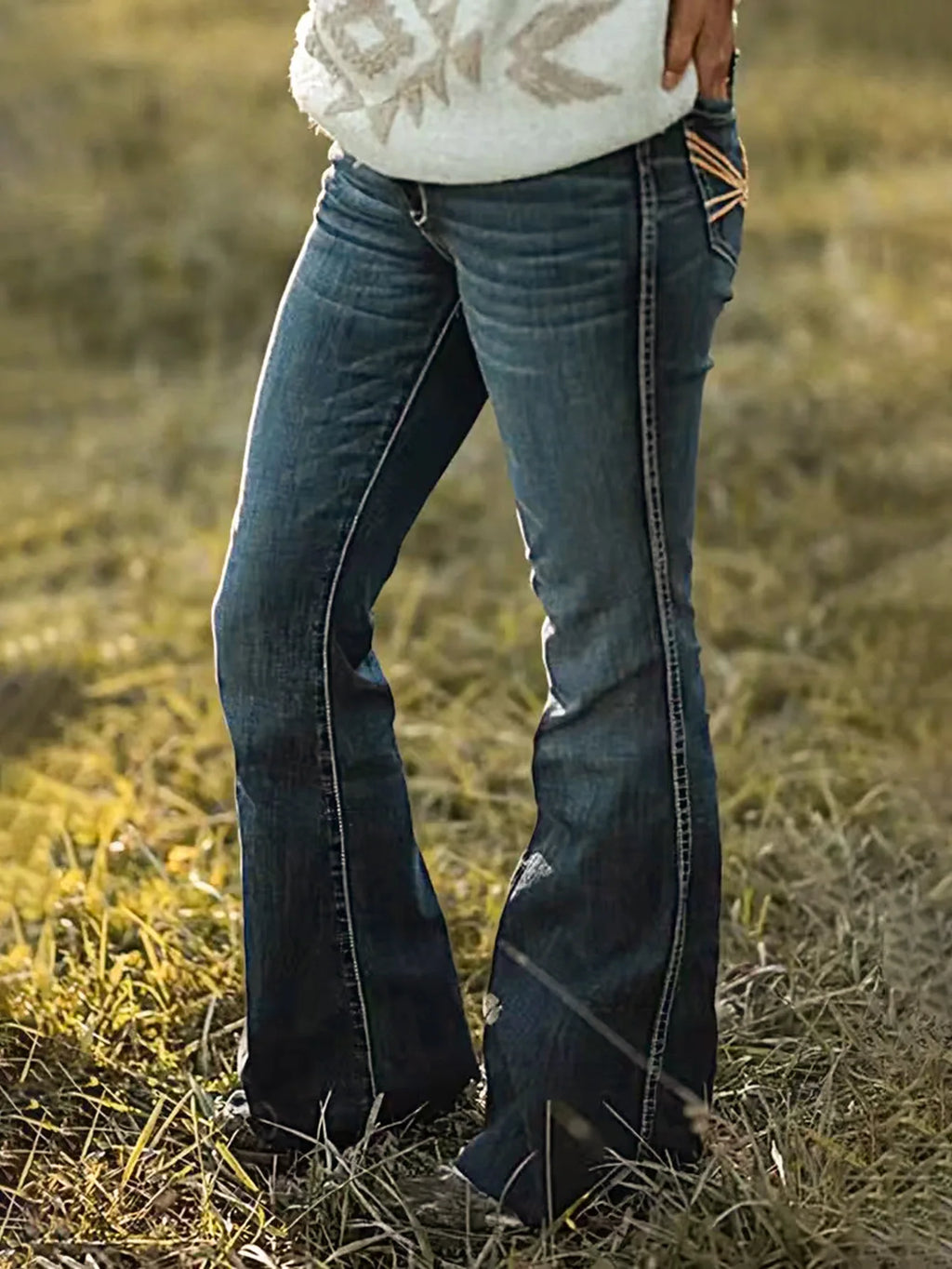 Women's vintage bell-bottom jeans with embroidered pockets.