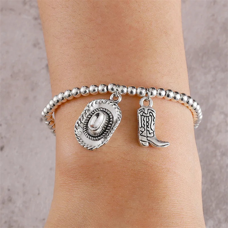 Vintage chain bracelet with cowboy hat and boots pendant.