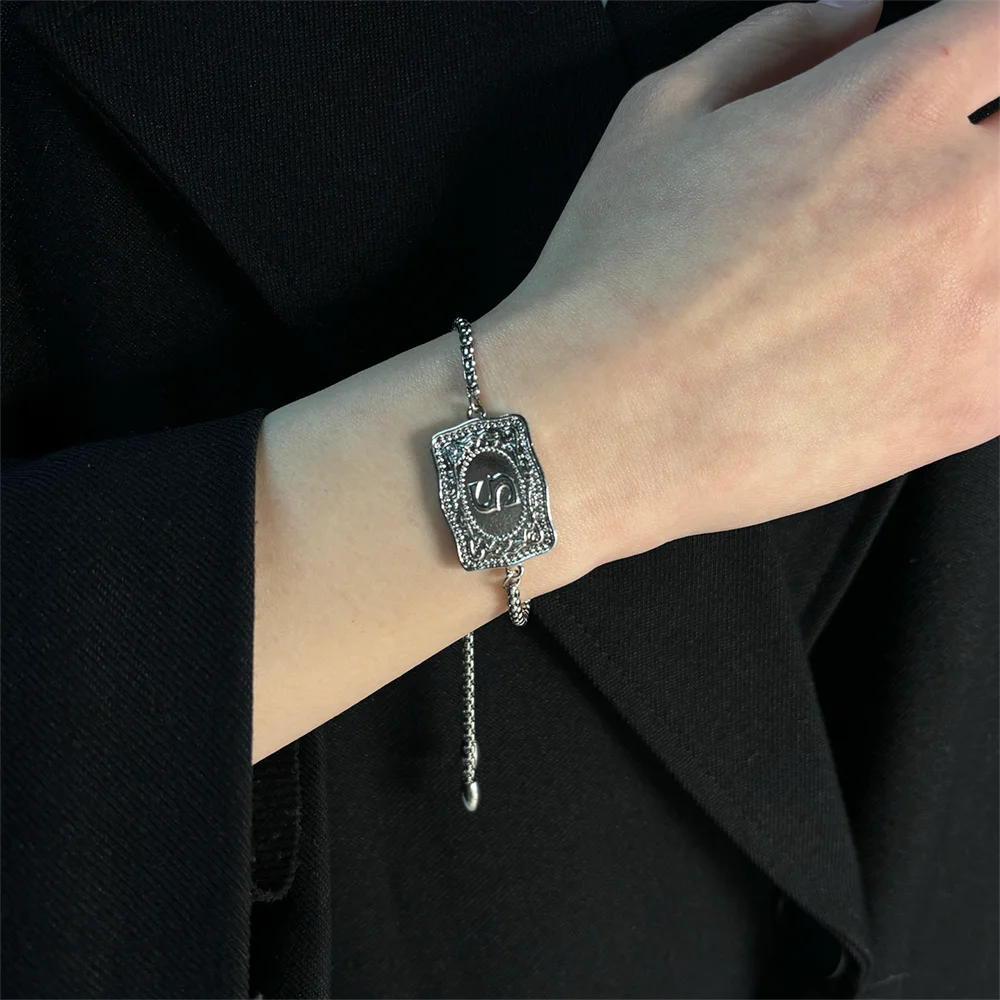 Women's bracelet with embossed gothic belt buckle and initial.
