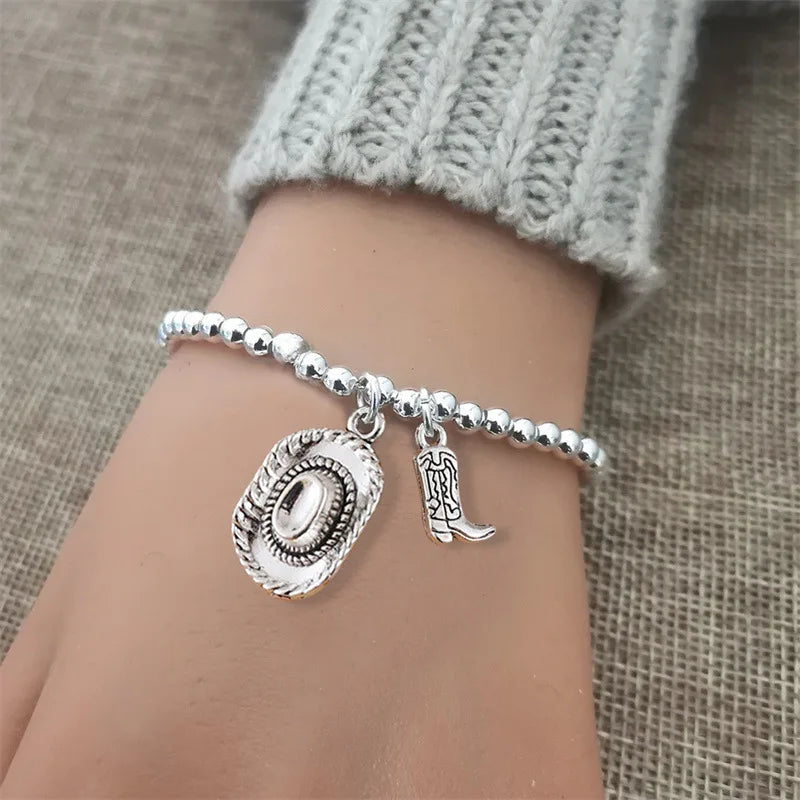 Vintage chain bracelet with cowboy hat and boots pendant.