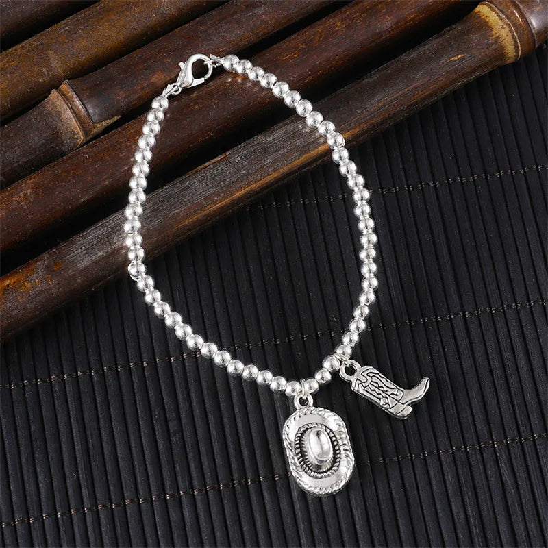 Vintage chain bracelet with cowboy hat and boots pendant.