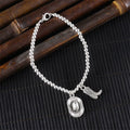 Vintage chain bracelet with cowboy hat and boots pendant.