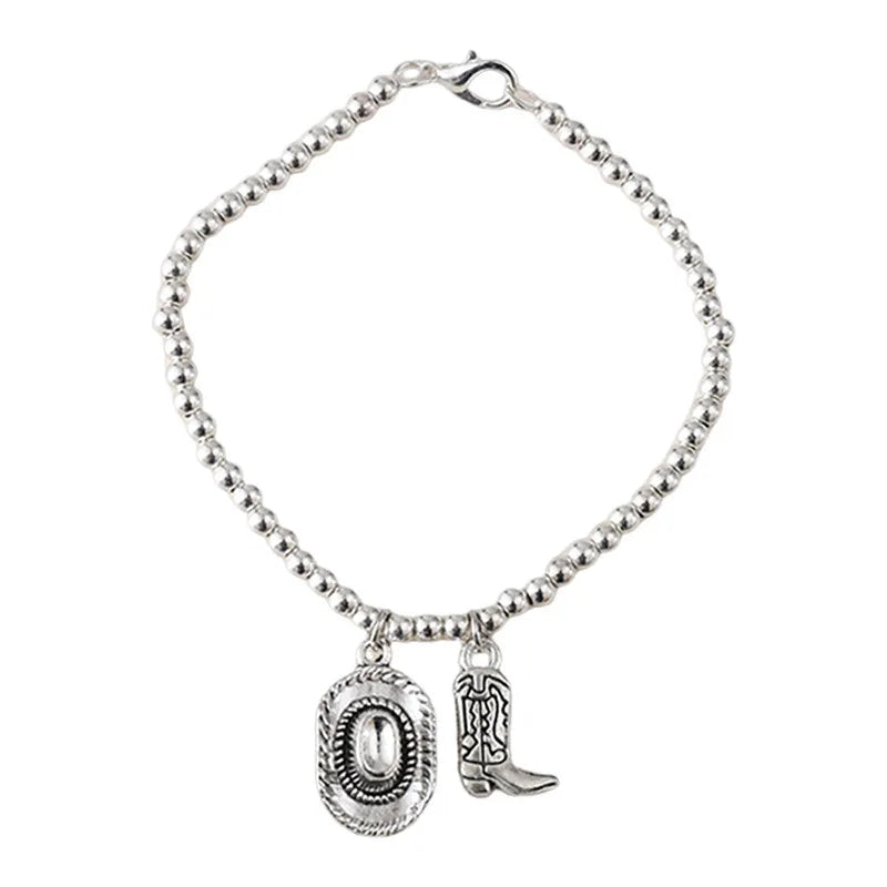 Vintage chain bracelet with cowboy hat and boots pendant.