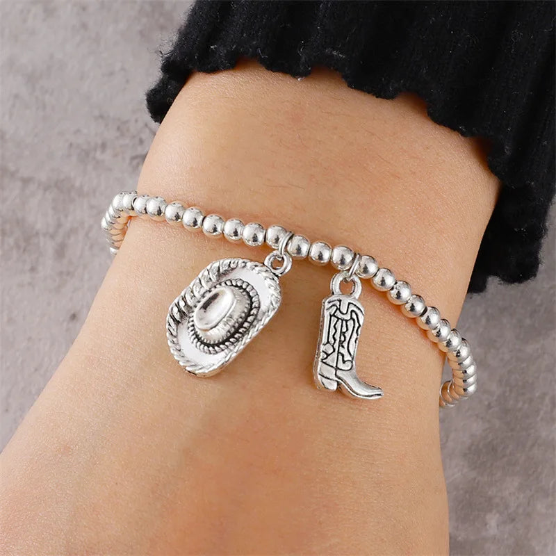 Vintage chain bracelet with cowboy hat and boots pendant.