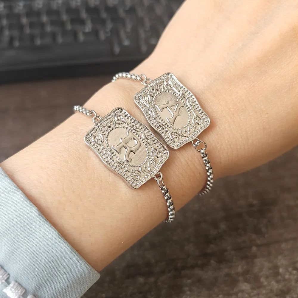 Women's bracelet with embossed gothic belt buckle and initial.