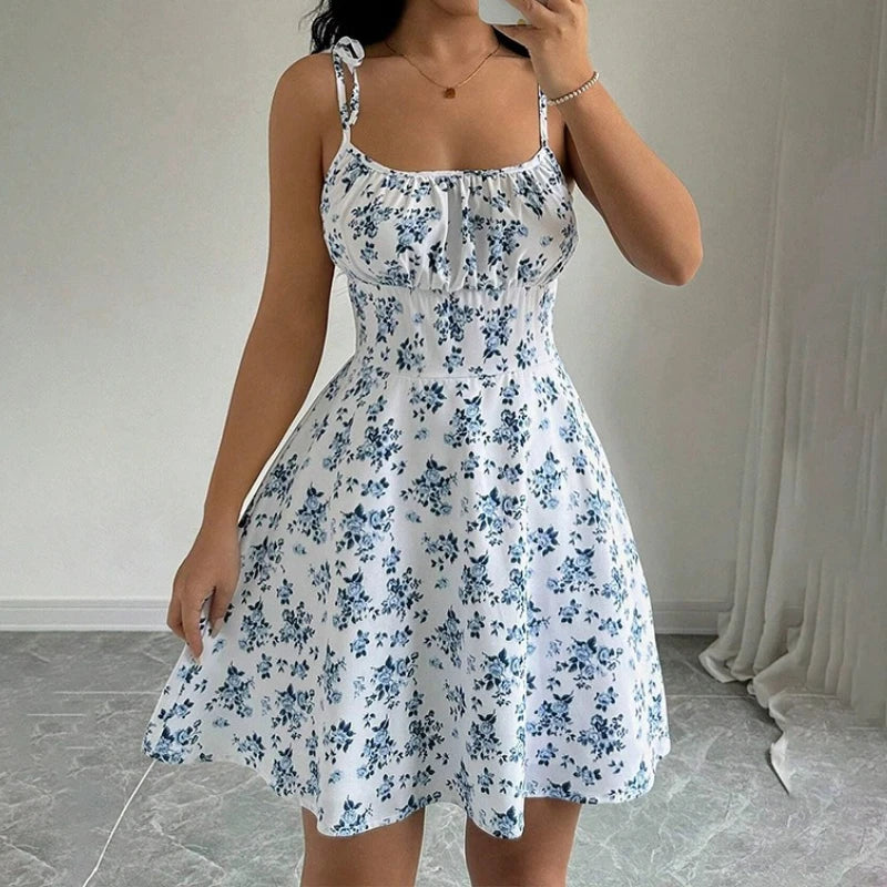 Women's short beach dress with floral print and thin straps.
